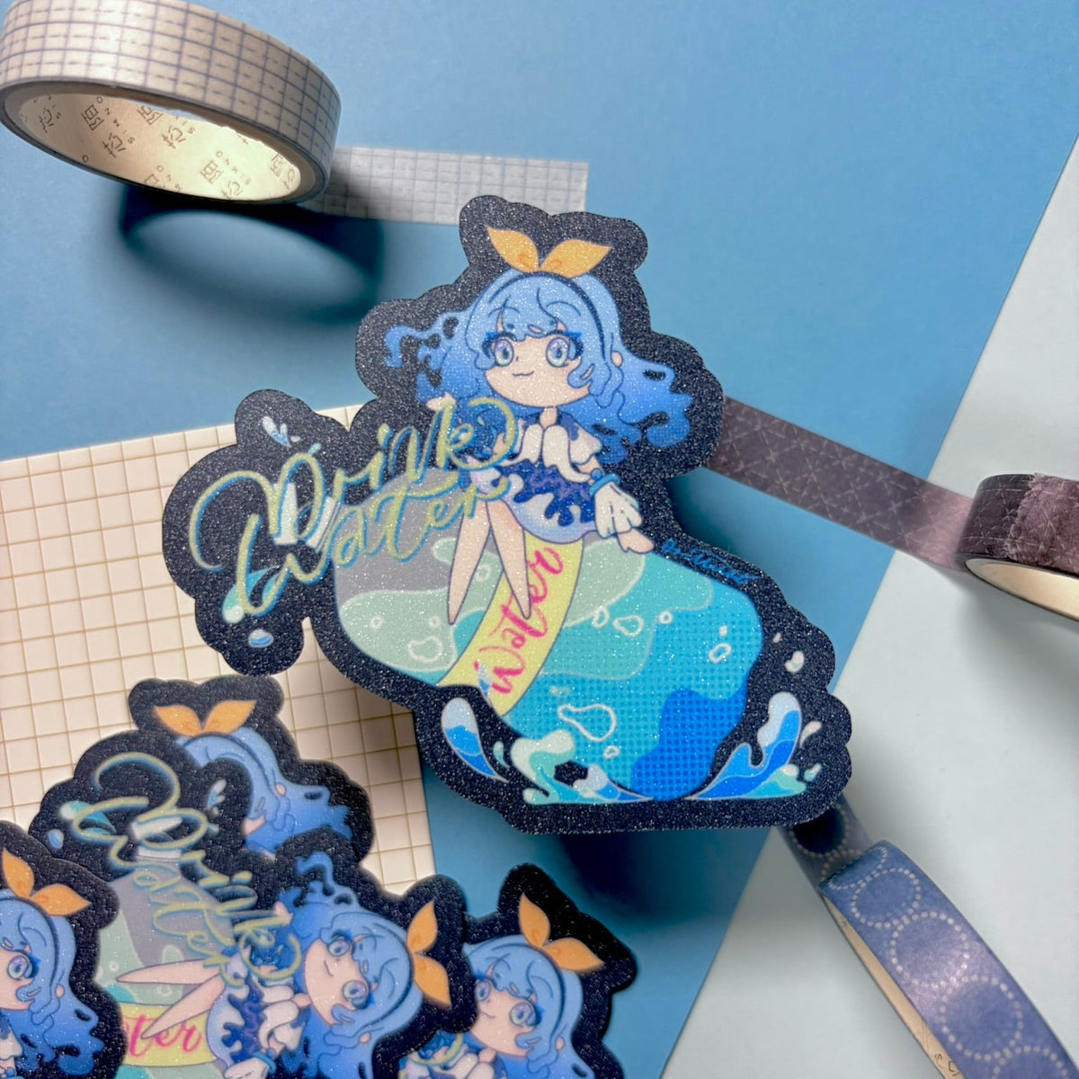 Decorative bookmarks with anime-style character on a blue surface
